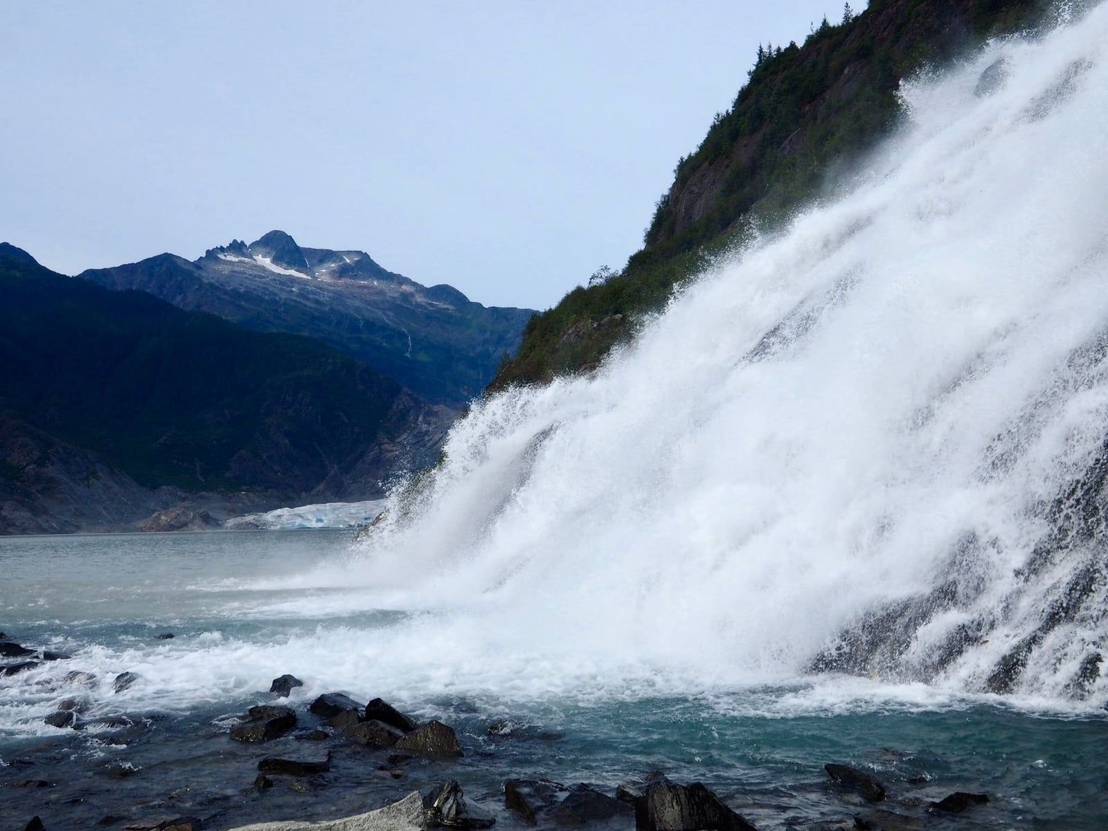Nugget Falls cascades down rocky slopes into the lake near Mendenhall Glacier.